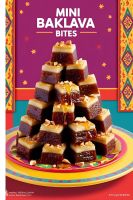 A tray of golden mini baklava bites, drizzled with honey syrup.