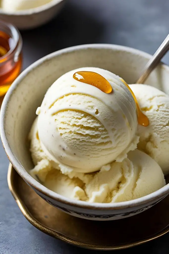 A close-up of chamomile ice cream in a decorative bowl, highlighting its smooth texture and garnished with chamomile petals.