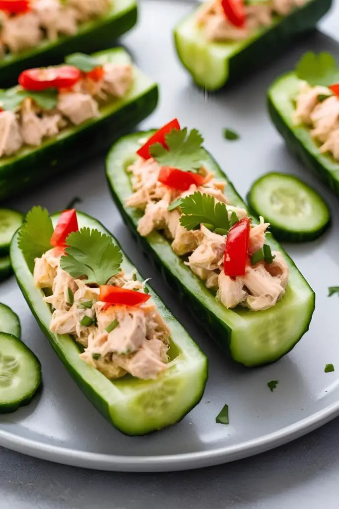 Multiple cucumber tuna salad boats on a serving tray, ready to eat.