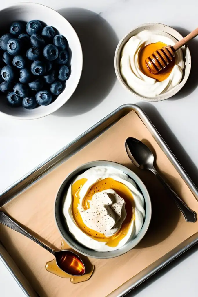 Greek yogurt-covered blueberries frozen on parchment paper