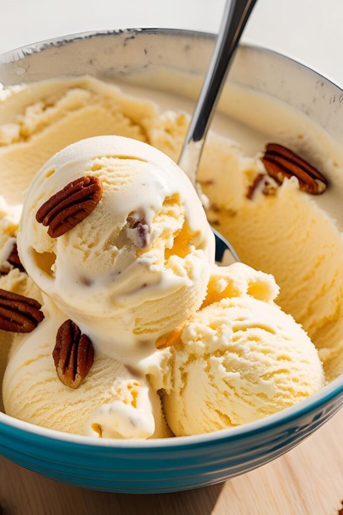 Close-up of butter pecan ice cream scooped into a waffle cone.