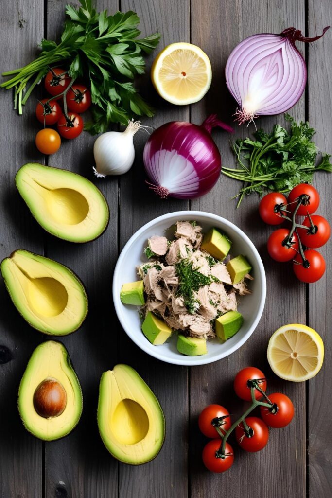 Stuffed avocado halves on a plate, filled with a colorful mix of tuna and vegetables.