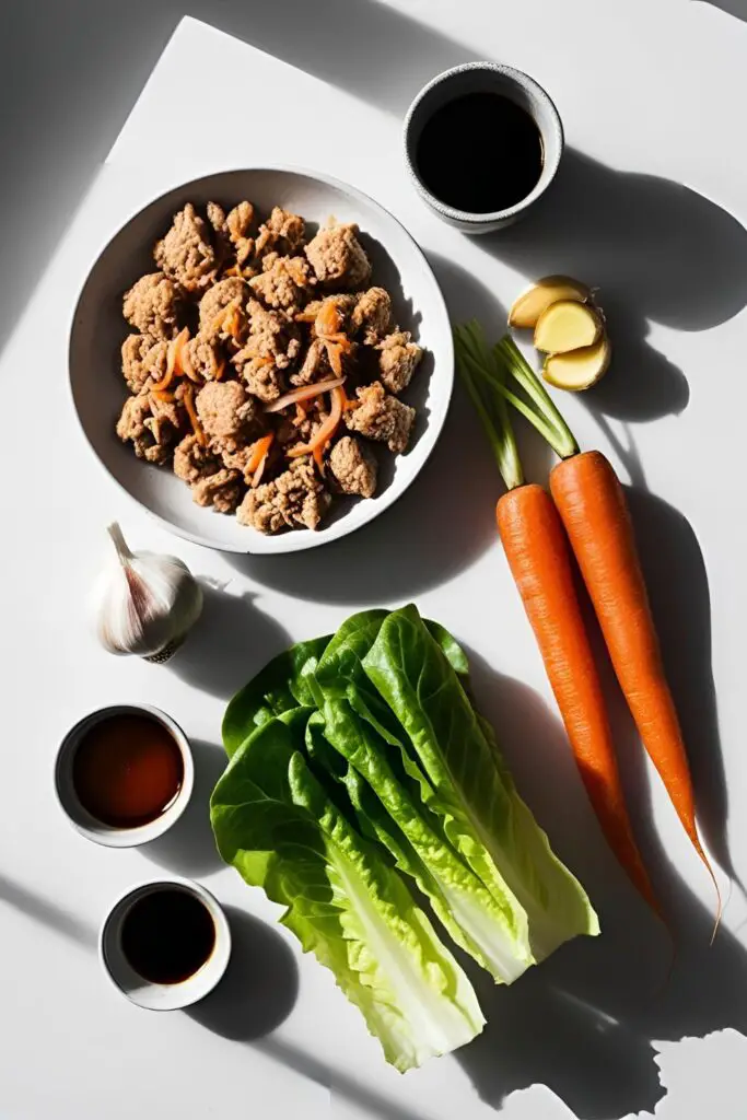 Teriyaki chicken lettuce wraps served on wooden platter with side dipping sauce