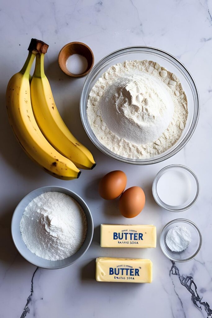 Ingredients for banana bread laid out on a kitchen counter, ready for mixing.