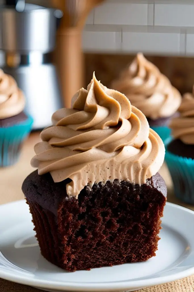 A piping bag filled with coffee frosting, ready to decorate a batch of cupcakes.