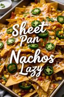 Sheet pan nachos loaded with cheese, chicken, beans, jalapeños on a crispy bake.