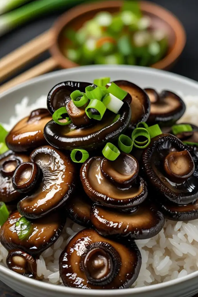 Plate of sautéed shiitake mushrooms with a side of steamed vegetables.