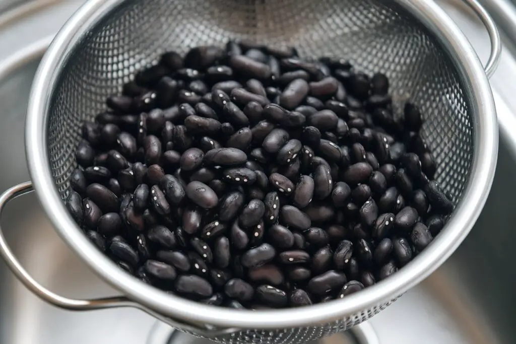 Thoroughly rinsed and drained black beans in a colander.