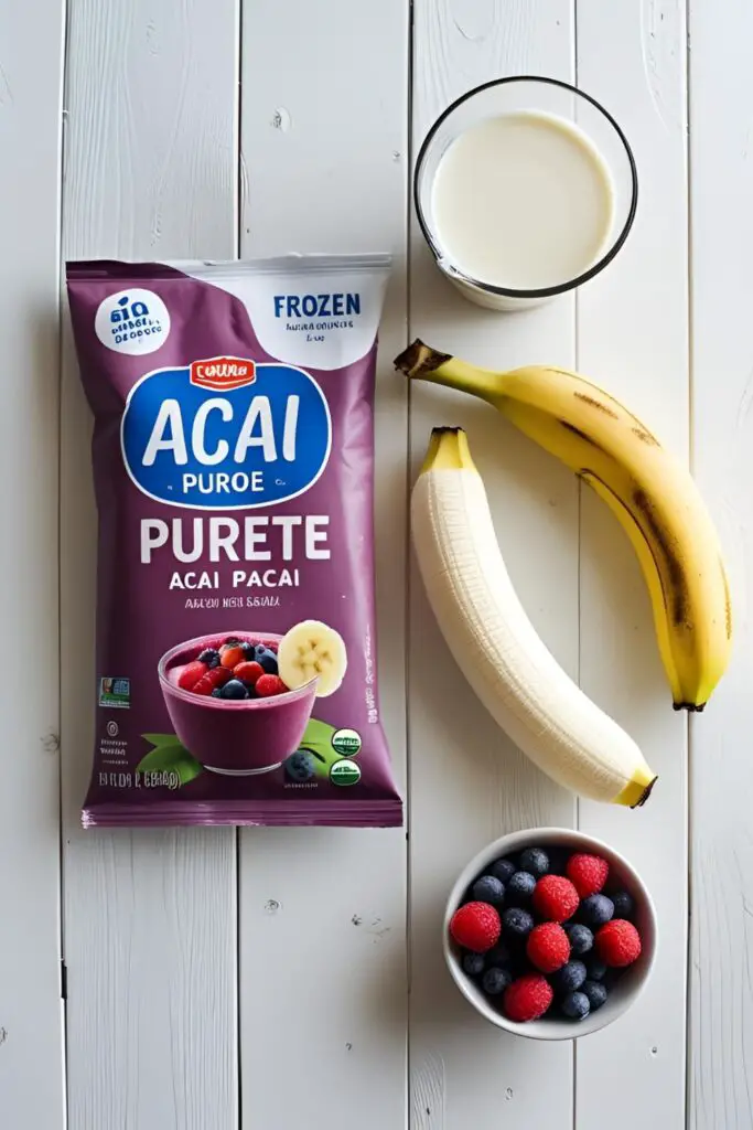  A flat lay collage of ingredients for an acai bowl recipe, including frozen acai puree, banana, mixed berries, and almond milk.

