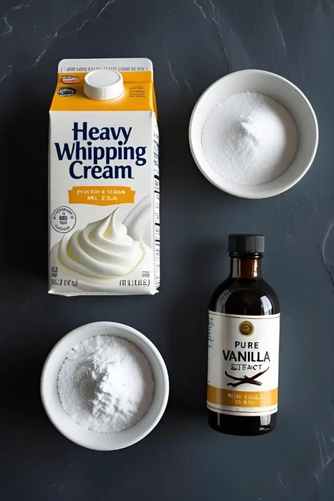 A flat lay of the three ingredients for homemade whipped cream: heavy cream, powdered sugar, and vanilla extract